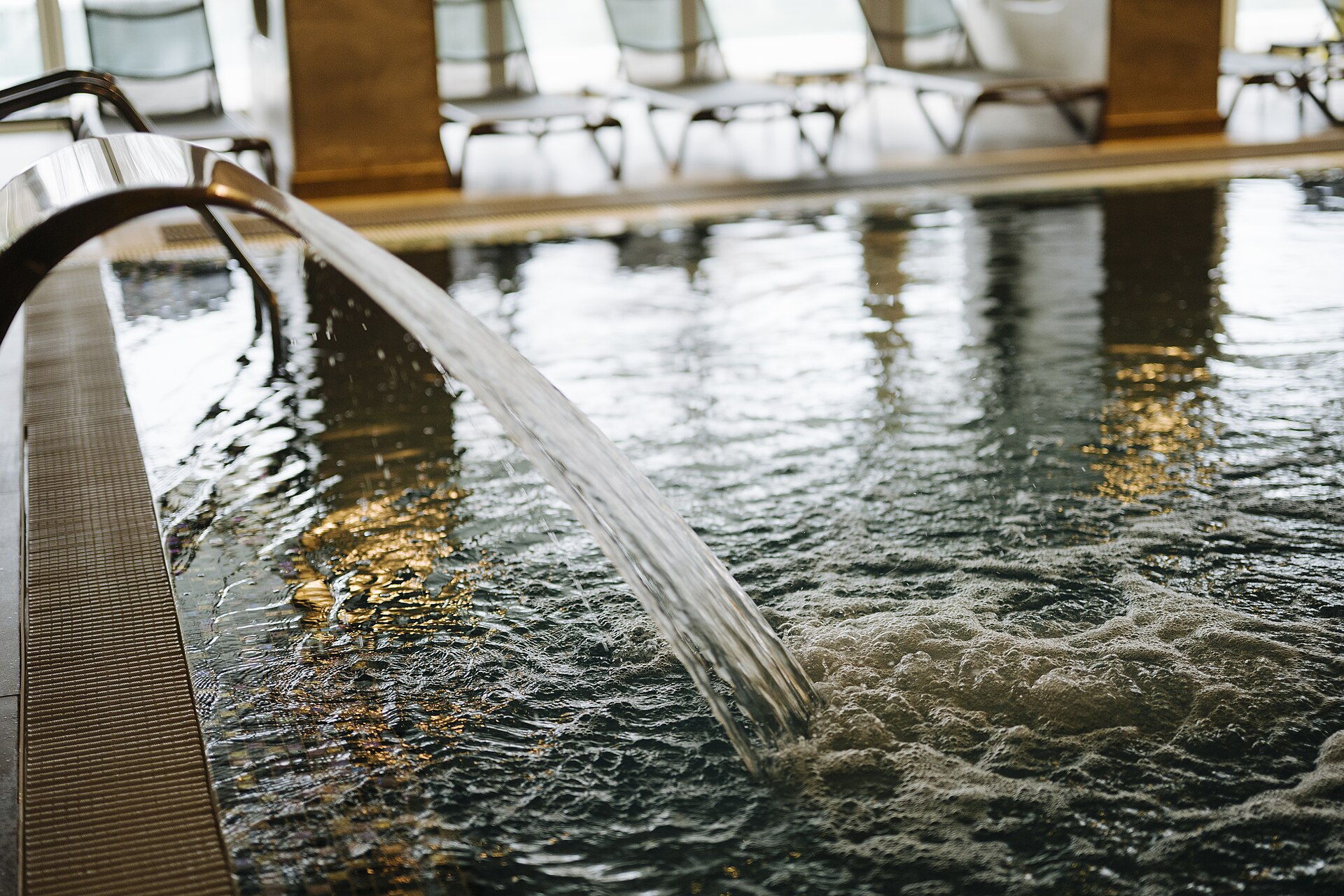 Hotel spa with water jet and loungers